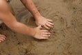 Hands of Young Child Playing in Wet Sand at the Beach Royalty Free Stock Photo