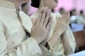 Hands of young couple praying in Thai wedding ceremony. Selective focus and shallow depth of field.