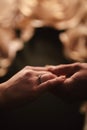 Hands of a young couple with a ring. close up of man giving diamond ring to woman Royalty Free Stock Photo