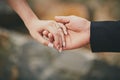 Hands of a young couple with a ring. close up of man giving diamond ring to woman Royalty Free Stock Photo