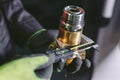 Hands of an engineer measures a metal part with a digital vernier caliper. Quality control of part machined on a lathe