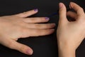 The hands of a young girl make a manicure