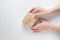 Hands of a young girl opening a gift box on a white background Royalty Free Stock Photo