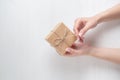 Hands of a young girl opening a gift box on a white background Royalty Free Stock Photo