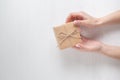 Hands of a young girl opening a gift box on a white background Royalty Free Stock Photo