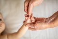 Hands of young great-grandson and old great-grandmother. Happy Family concept. Beautiful conceptual image of Maternity. selective Royalty Free Stock Photo