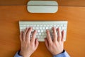 Hands of a young man on a computer keyboard, top view. The concept of learning. doing business and high technology Royalty Free Stock Photo