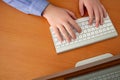Hands of a young man on a computer keyboard, top view. The concept of learning. doing business and high technology Royalty Free Stock Photo