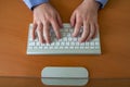 Hands of a young man on a computer keyboard, top view. The concept of learning. doing business and high technology Royalty Free Stock Photo