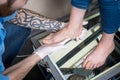 The hands of a young man doctor orthopedist conducts diagnostics, foot foot test of a woman, for the manufacture of individual, or Royalty Free Stock Photo