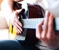 Hands of young man playing guitar. Close-up Royalty Free Stock Photo