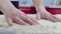 Hands of young man prepare dough close up