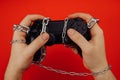 Hands of a young man with are tied and holds a game controller in his hands, concept of game addiction Royalty Free Stock Photo