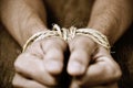 The hands of a young man tied with rope Royalty Free Stock Photo