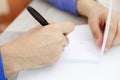 Hands of a young man writing on a piece of paper Royalty Free Stock Photo