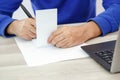 Hands of a young man writing on a piece of paper Royalty Free Stock Photo