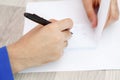 Hands of a young man writing on a piece of paper Royalty Free Stock Photo