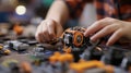 Hands of a young person interact with a complex mechanical model on a tabletop