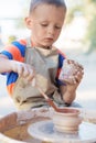 Hands of young potter, creating an earthen jar on the circle, cl Royalty Free Stock Photo