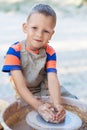 Hands of young potter, creating an earthen jar on the circle, cl Royalty Free Stock Photo