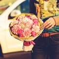 Hands of young unidentified woman holding a beautiful bouquet of