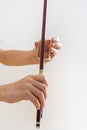 Hands of a young violinist rosin his bow on a light background, vertical Royalty Free Stock Photo