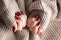 Hands of a young woman with dark red manicure on nails Royalty Free Stock Photo