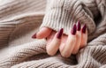 Hands of a young woman with dark red manicure on nails Royalty Free Stock Photo