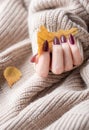 Hands of a young woman with dark red manicure on nails Royalty Free Stock Photo