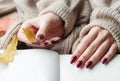 Hands of a young woman with dark red manicure on nails Royalty Free Stock Photo