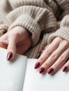 Hands of a young woman with dark red manicure on nails Royalty Free Stock Photo