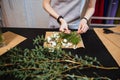 Hands of young woman florist making bouquet with white flowers Royalty Free Stock Photo