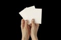 Hands of young woman with golden nail polish holding three blank business cards mockup, stationery template Royalty Free Stock Photo