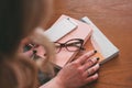 Hands of a young woman holding a diary, phone, magazines, modern life style Royalty Free Stock Photo