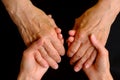 Hands of young woman holding hands of an elderly woman Royalty Free Stock Photo