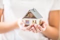 Hands of young woman holding model house Royalty Free Stock Photo