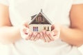 Hands of young woman holding model house Royalty Free Stock Photo