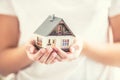 Hands of young woman holding model house Royalty Free Stock Photo