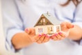 Hands of young woman holding model house Royalty Free Stock Photo