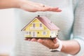 Hands of young woman holding model house Royalty Free Stock Photo