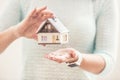 Hands of young woman holding model house Royalty Free Stock Photo