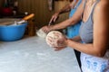 Hands of a young woman, kneading dough to make bread or pizza at home. Production of flour products. Making dough by Royalty Free Stock Photo