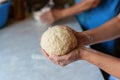 Hands of a young woman, kneading dough to make bread or pizza at home. Production of flour products. Making dough by Royalty Free Stock Photo