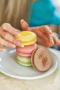 Hands of young woman and macaroons Royalty Free Stock Photo