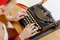 Hands of a young woman with an old typewriter Royalty Free Stock Photo