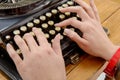 Hands of a young woman with an old typewriter Royalty Free Stock Photo