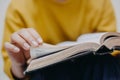 Hands young woman open bible.