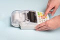 Hands of a young woman press a button of a cash register to break through a check after buying a product. Business idea Royalty Free Stock Photo