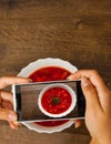 Hands young woman taking photo of food on smartphone, photographing meal with mobile camera. Royalty Free Stock Photo