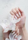 Hands of a young woman with white manicure on nails Royalty Free Stock Photo